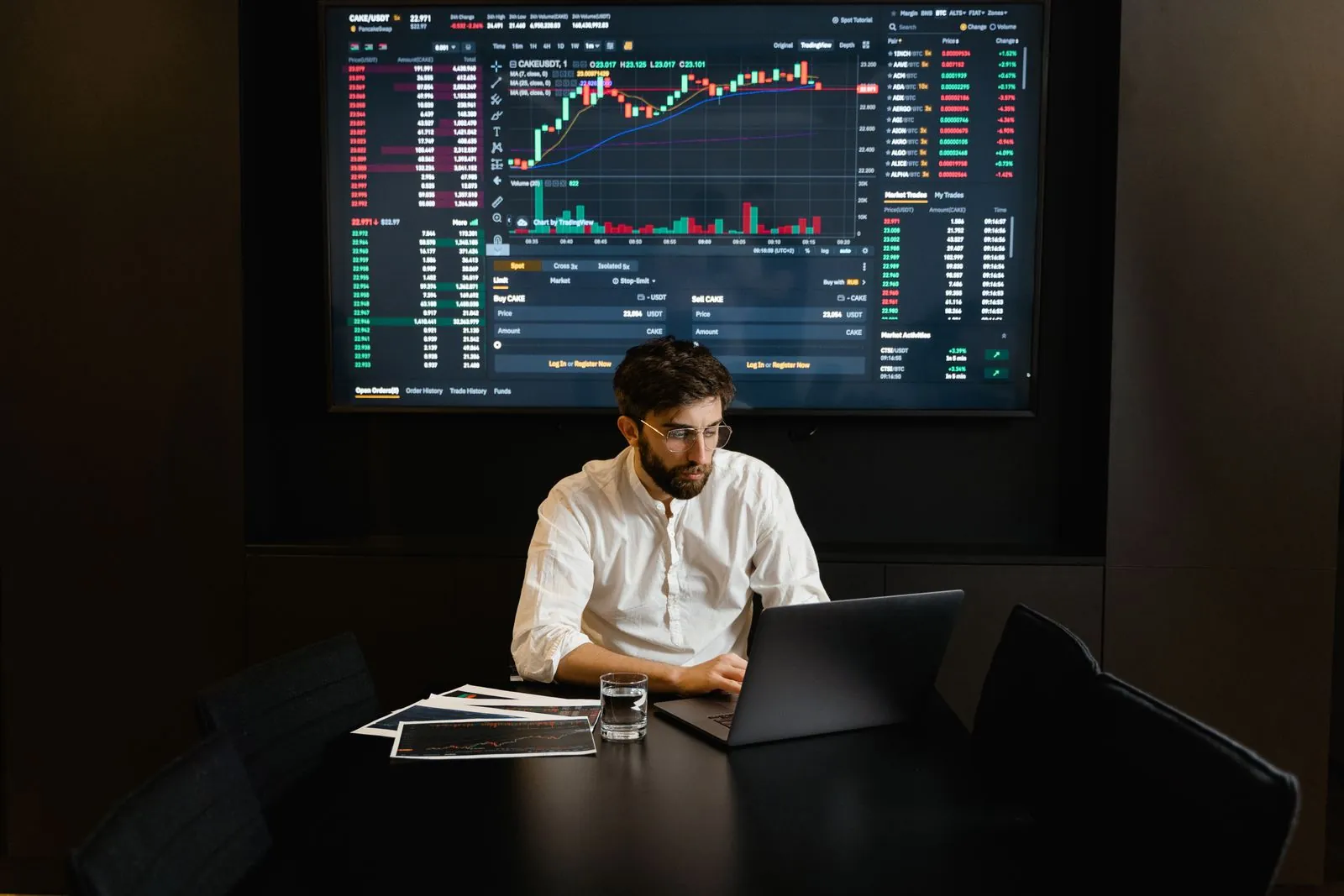 An analyst reviews market information on a laptop.